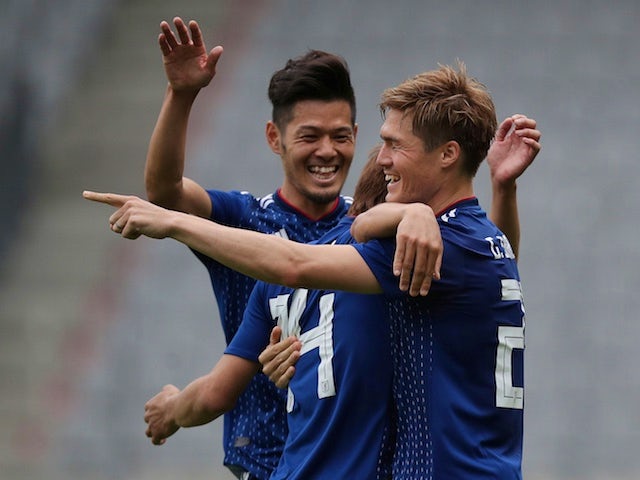 Japan players celebrate during their World Cup warm-up match against Paraguay on June 12, 2018