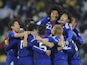 Japan's players celebrate after reaching the knockout stages of the 2014 World Cup
