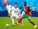 Medhi Benatia and Sardar Azmoun in action during the World Cup group game between Morocco and Iran on June 15, 2018