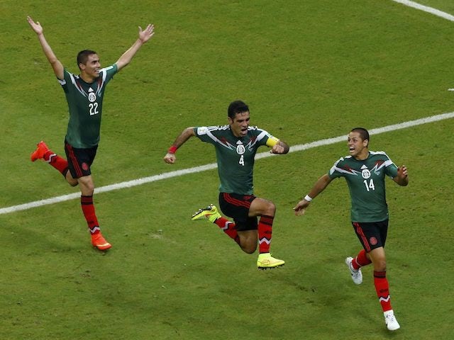 Mexico players celebrate beating Croatia at the 2014 World Cup