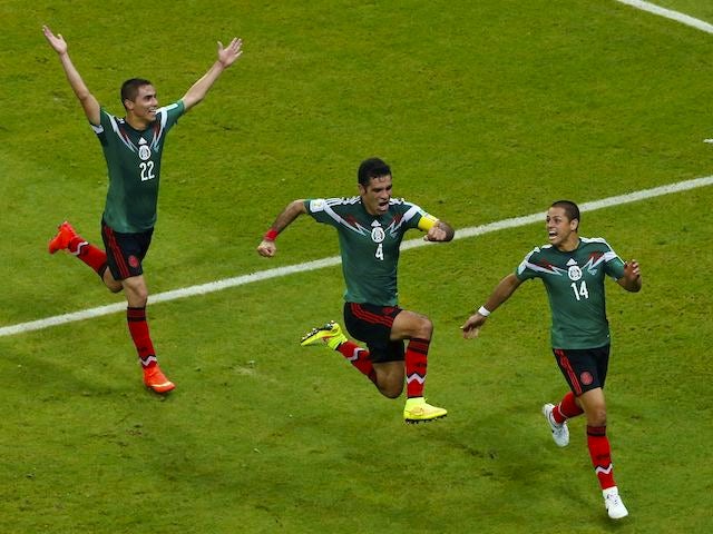 Mexico players celebrate beating Croatia at the 2014 World Cup