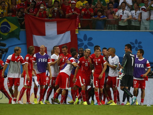 Switzerland's players celebrate qualifying from their group at the 2014 World Cup
