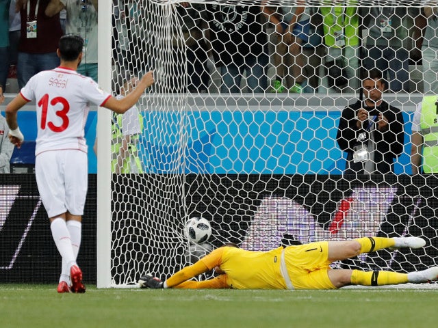Tunisia's Ferjani Sassi scores their first goal past England's Jordan Pickford from the penalty spot on June 18, 2018