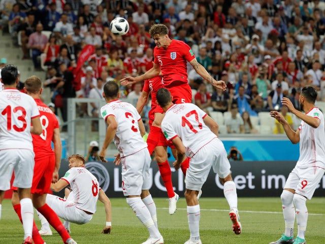 England's John Stones heads at goal before Harry Kane scores their first goal from the rebound in the match against Tunisia on June 18, 2018
