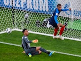Peru's Pedro Gallese looks dejected as France's Kylian Mbappe celebrates scoring their first goal on June 21, 2018