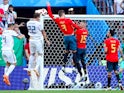 Spain's Gerard Pique handles the ball in the area resulting in a penalty being awarded to Russia on July 1, 2018