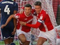 Matty Pearson celebrates with Angus MacDonald after scoring Barnsley's first goal against Nottingham Forest on August 15, 2017