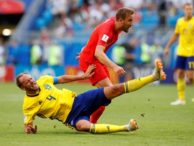 England's Harry Kane in action with Sweden's Andreas Granqvist on July 7, 2018