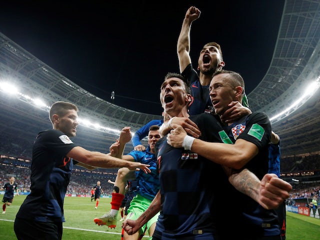 Croatia players celebrate with Mario Mandzukic after scoring the winning goal in their World Cup semi-final with England on July 11, 2018