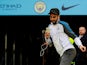 Riyad Mahrez of Leicester City in front of the Manchester City badge during the 2017-18 Premier League season