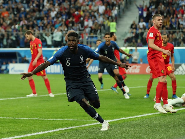 France defender Samuel Umtiti wheels away in celebration after scoring the opening goal of his side's World Cup semi-final with Belgium on July 10, 2018