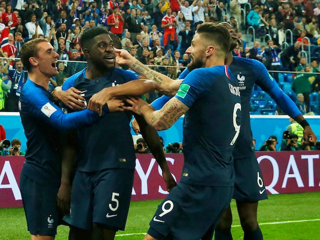 France defender Samuel Umtiti celebrates with teammates after scoring the opening goal of his side's World Cup semi-final with Belgium on July 10, 2018