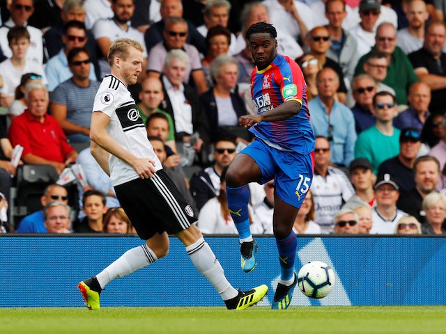 Jeffrey Schlupp puts Andre Schurrle under pressure during the Premier League clash between Fulham and Crystal Palace on August 11, 2018