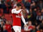 Mesut Ozil wipes his nose on his shirt during the Premier League game between Arsenal and Manchester City on August 12, 2018