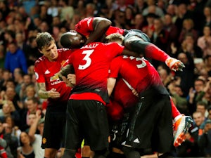 Paul Pogba is mobbed by his Manchester United teammates after scoring against Leicester City on August 8, 2018
