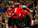 Paul Pogba is mobbed by his Manchester United teammates after scoring against Leicester City on August 8, 2018