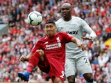 Roberto Firmino and Angelo Ogbonna in action during the Premier League game between Liverpool and West Ham United on August 12, 2018