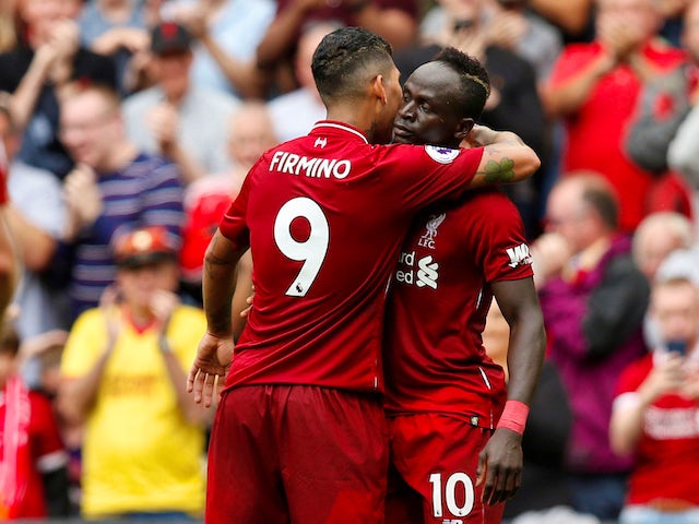 Sadio Mane celebrates with Roberto Firmino after scoring during the Premier League game between Liverpool and West Ham United on August 12, 2018
