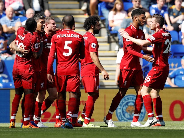 Roberto Firmino celebrates with his Liverpool teammates during his side's Premier League clash with Leicester City on September 1, 2018