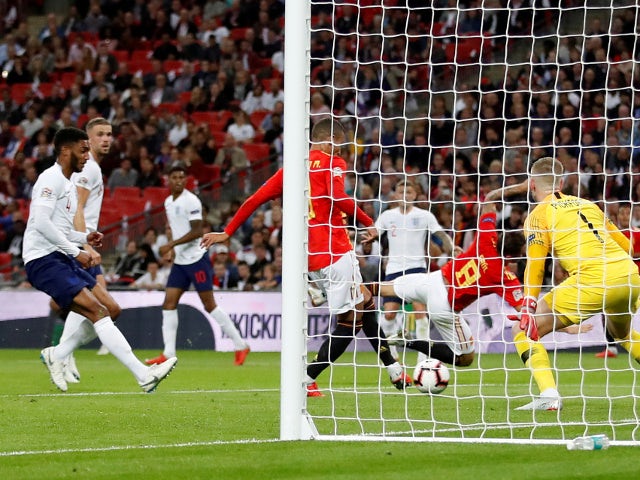 Spain's Rodrigo scores their second goal past England's Jordan Pickford during the UEFA Nations League match on September 8
