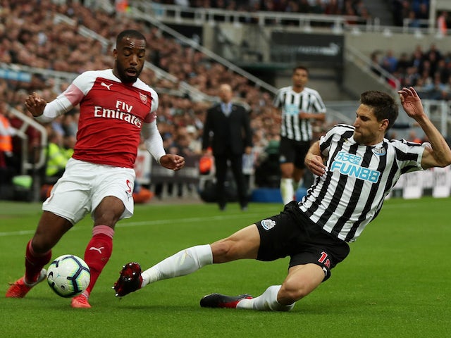 Alexandre Lacazette and Federico Fernandez in action during the Premier League game between Newcastle United and Arsenal on September 15, 2018
