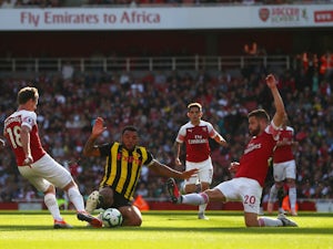 Arsenal's Nacho Monreal and Shkodran Mustafi challenge Troy Deeney of Watford during their Premier League clash on September 29, 2018