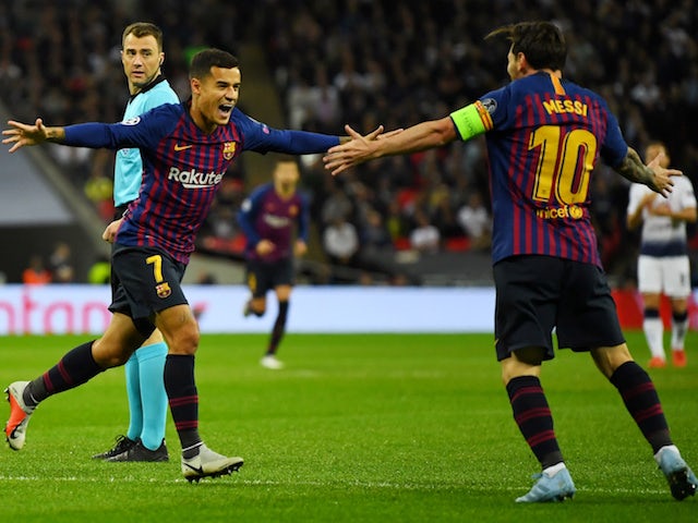 Barcelona midfielder Philippe Coutinho celebrates with Lionel Messi after scoring the opening goal in his side's Champions League clash with Tottenham Hotspur on October 3, 2018