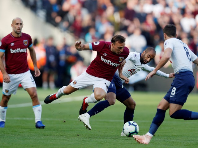 West Ham United's Mark Noble and Tottenham Hotspur's Lucas Moura battle for the ball at the London Stadium on October 20, 2018