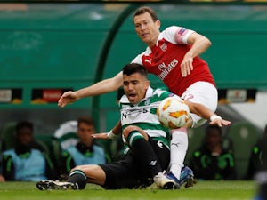 Marcos Acuna and Stephan Lichtsteiner in action during the Europa League group game between Sporting Lisbon and Arsenal on October 25, 2018