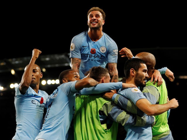 Manchester City players celebrate scoring against Manchester United on November 11, 2018