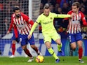 Barcelona's Arthur runs away from Atletico Madrid pair Antoine Griezmann and Diego Costa