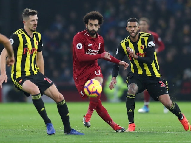 Liverpool's Mohamed Salah flanked by two Watford players during their Premier League clash on November 24, 2018