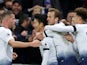Son Heung-min is mobbed by his Tottenham Hotspur teammates after adding his name to the scoresheet against Chelsea on November 24, 2018