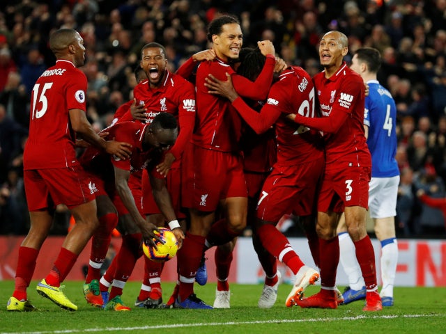 Divock Origi is mobbed by his Liverpool teammates after his dramatic winner against Everton on December 2, 2018