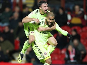 Blades cut down Brentford to stay in touch at the top