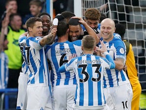 Mathias Jorgensen celebrates his early opener with teammates during the Premier League game between Huddersfield Town and Brighton & Hove Albion on December 1, 2018