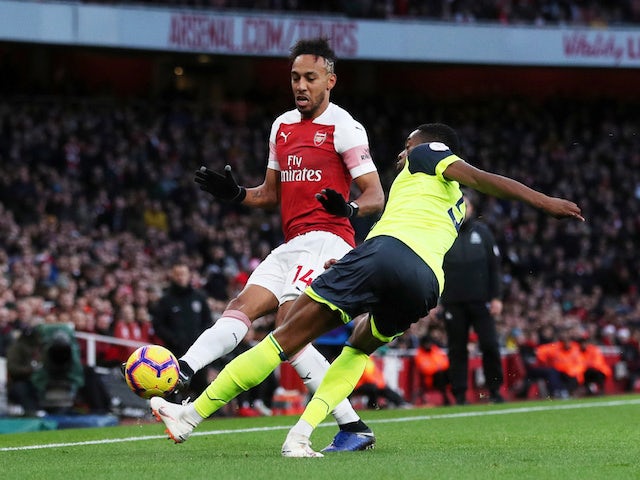 Arsenal's Pierre-Emerick Aubameyang in action with Huddersfield Town's Terence Kongolo on December 8, 2018