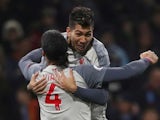 Roberto Firmino celebrates scoring with Liverpool teammate Virgil van Dijk on December 5, 2018