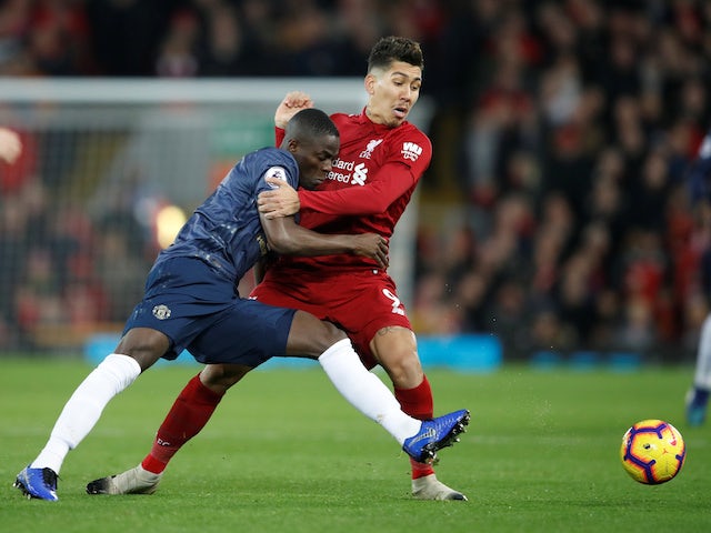 Eric Bailly and Roberto Firmino in action during the Premier League game between Liverpool and Manchester United on December 16, 2018