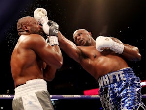 Whyte recovers from ninth-round knockdown to beat Rivas