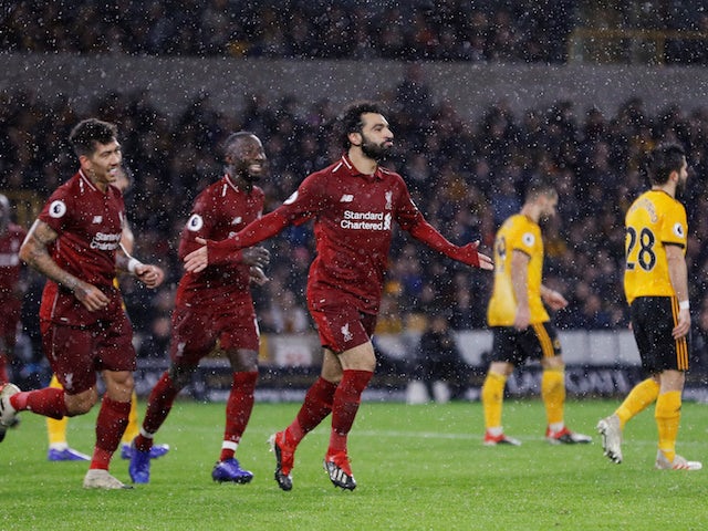 Liverpool striker Mohamed Salah celebrates after scoring the opening goal against Wolverhampton Wanderers on December 21, 2018