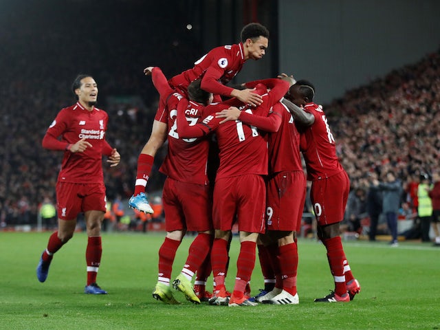Liverpool players celebrate scoring against Arsenal on December 29, 2018