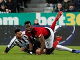 Manchester United's Paul Pogba on the receiving end of a tackle from Newcastle United's Jamaal Lascelles in the Premier League on January 2, 2019.