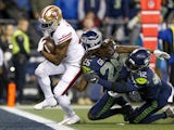 San Francisco 49ers running back Raheem Mostert (31) rushes for a touchdown against Seattle Seahawks cornerback Shaquill Griffin (26) and defensive back Lano Hill (42) during the fourth quarter at CenturyLink Field on December 30, 2019