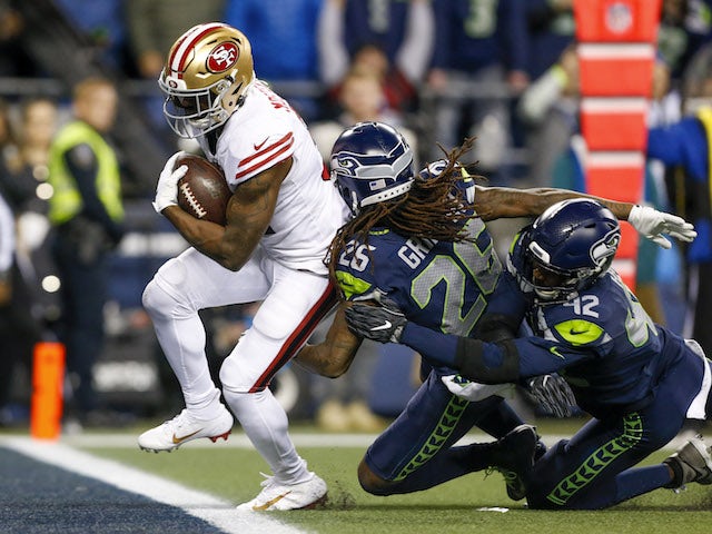 San Francisco 49ers running back Raheem Mostert (31) rushes for a touchdown against Seattle Seahawks cornerback Shaquill Griffin (26) and defensive back Lano Hill (42) during the fourth quarter at CenturyLink Field on December 30, 2019