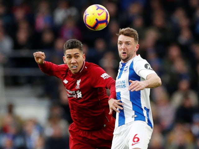Liverpool's Roberto Firmino and Brighton & Hove Albion's Dale Stephens challenge for the ball on January 12, 2019.