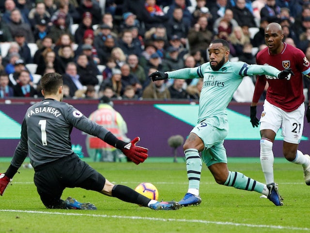 West Ham goalkeeper Lukasz Fabianski thwarts Arsenal striker Alexandre Lacazette during their Premier League clash on January 12, 2019