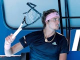 An angry Alexander Zverev brandishes his smashed racket after crashing out of the Australian Open on January 21, 2019