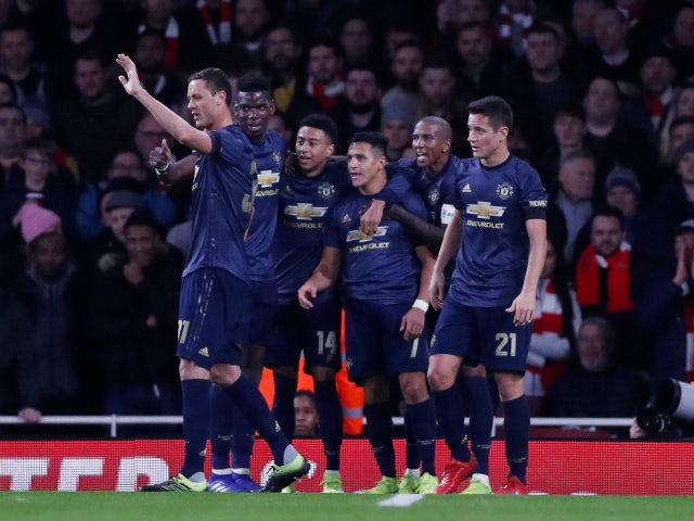 Alexis Sanchez is congratulated by his Manchester United teammates after opening the scoring against Arsenal on January 25, 2019