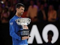 Novak Djokovic poses with the Australian Open trophy on January 27, 2019
